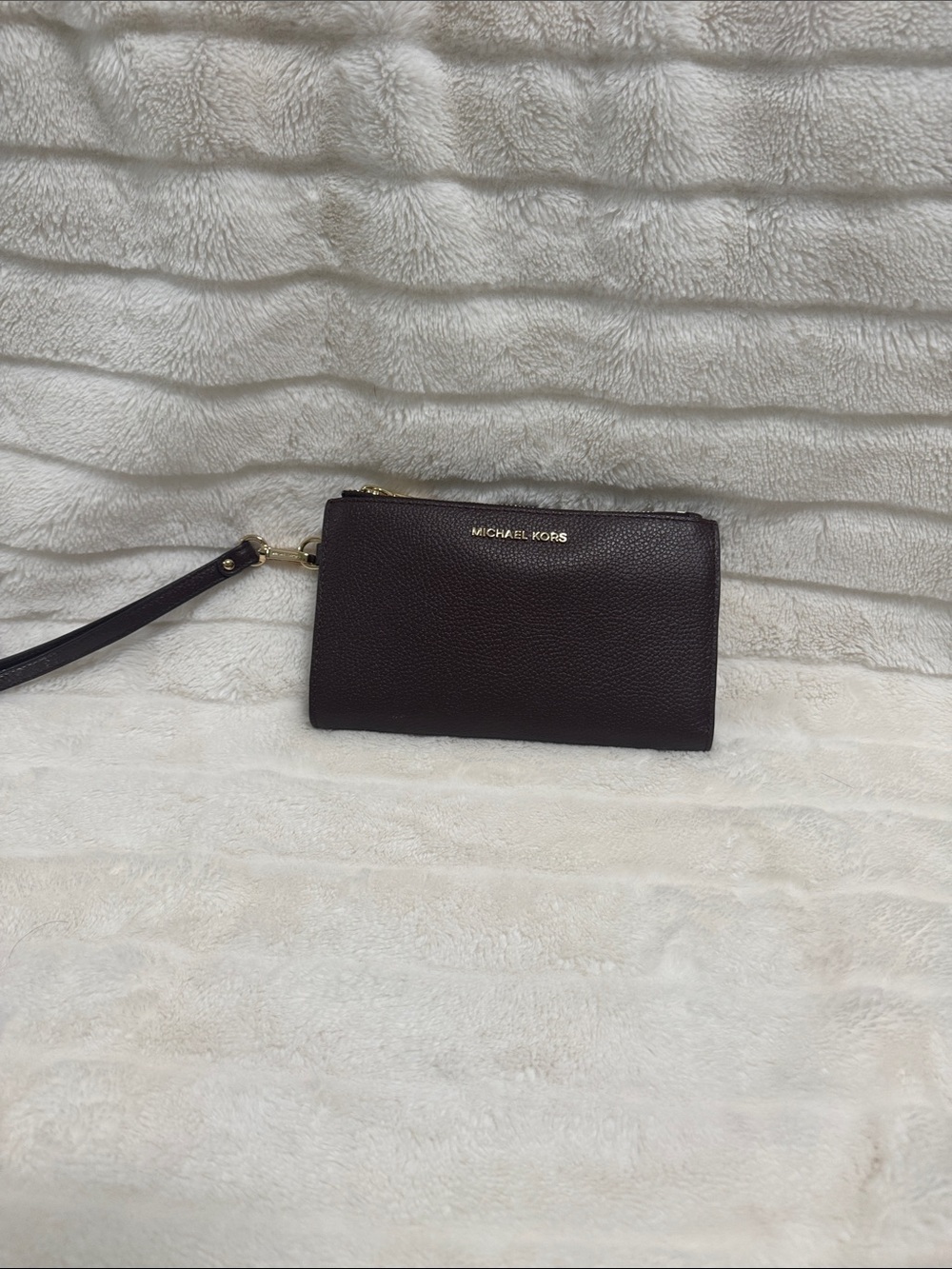 Michael Kors Pebbled Leather Wristlet in plum with Gold Hardware